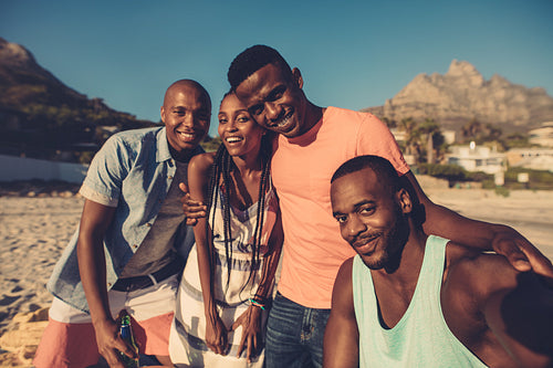 Group of friends taking selfie on the seashore.