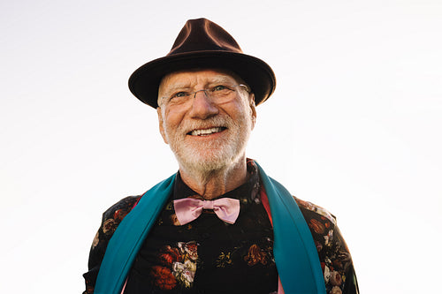 Senior man smiling while standing outdoors