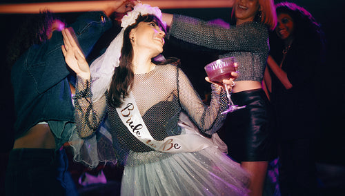Bride-to-be enjoying her bachelorette party celebration with friends and champagne