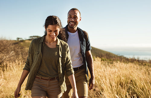Happy couple hiking on a hillock