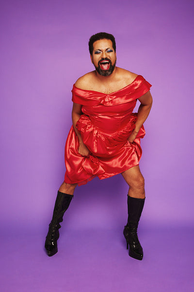 Gender queer male performing on purple background