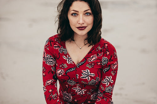 Beautiful female model posing confidently outdoors