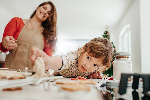 Mother and daughter making Christmas cookies.
