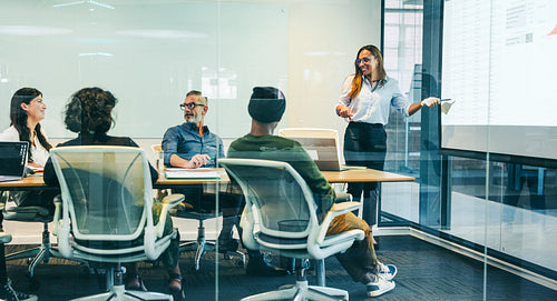 Smiling businesswoman presenting financial data to her colleagues