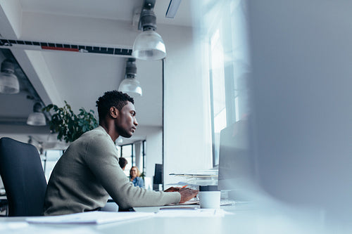 Young african man working in office