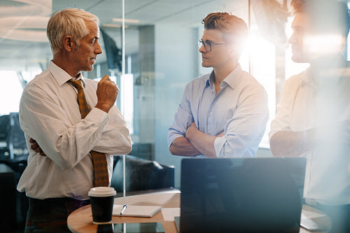 Senior boss giving business instructions to coworkers