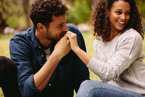 Man kissing woman's hand