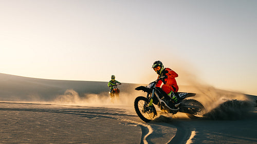 Dirt bikers off roading on sand dunes
