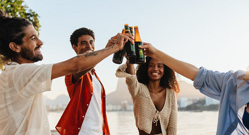 Young adults toasting in a cheerful outdoor celebration