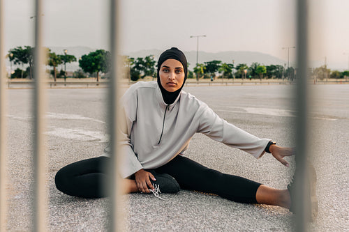 Woman with a hijab looking at the camera while working out