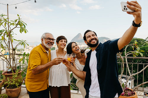 Family enjoying a rooftop gathering with scenic views and smiles