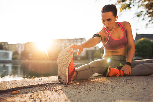 Fitness woman stretching before a run