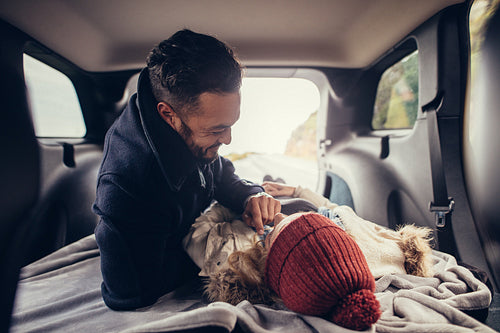 Romantic couple lying in car trunk