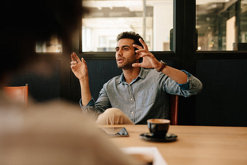 Man explaining business strategy to colleagues in conference room