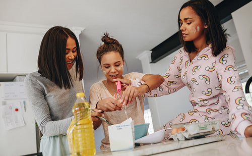 Girls preparing breakfast in kitchen