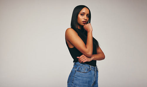 Self-confident young woman looking at the camera in a studio
