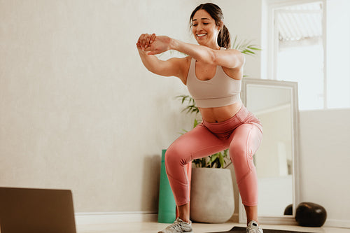 Woman doing stretching workout at home