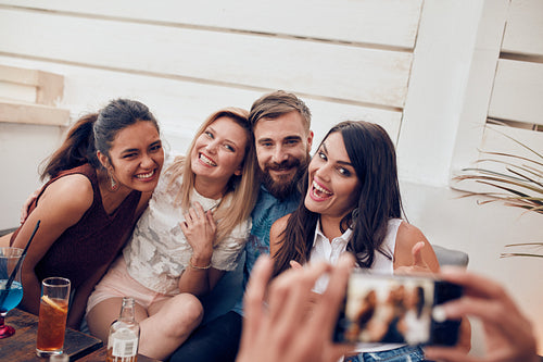 Group of young people at party posing for a photo