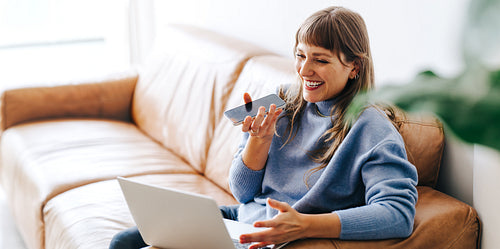 Happy young businesswoman having a phone call discussion in an office