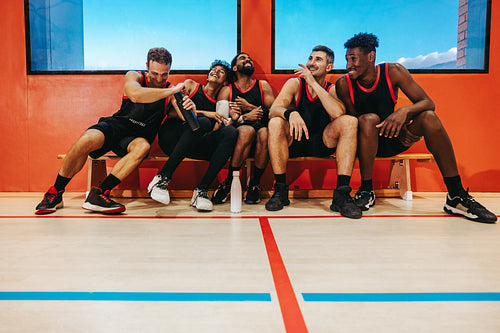 Basketball players enjoying team bench moments