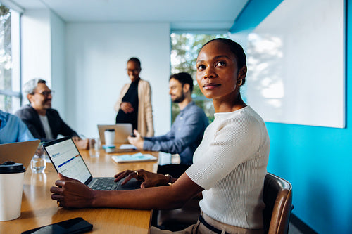 Group of professionals working intently during a business meeting in a bright office