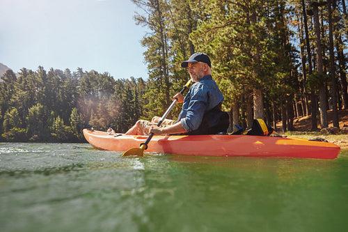 Mature man with kayak in a lake