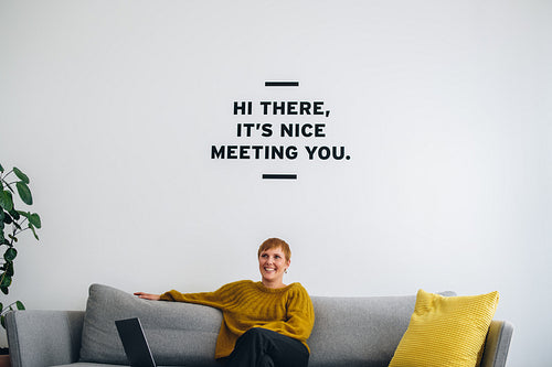 Smiling businesswoman on sofa in lobby