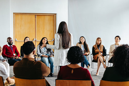 Dynamic Synergy: Professionals engaged in discussion during a business conference.