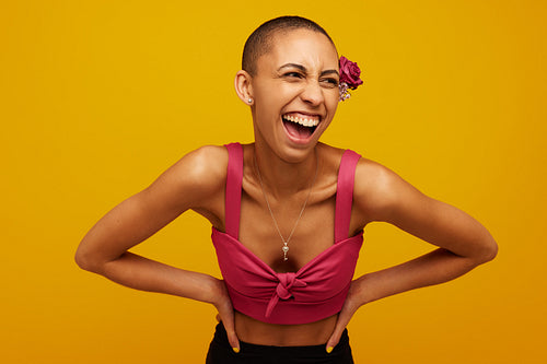 Woman in stylish outfit on yellow background