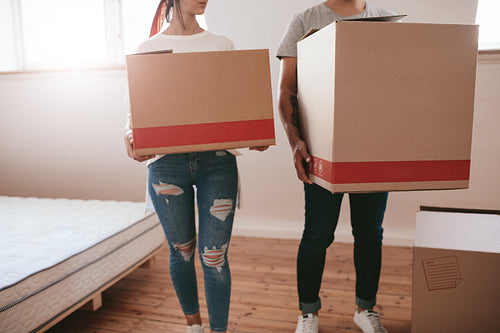 Couple with big cardboard boxes moving to new place