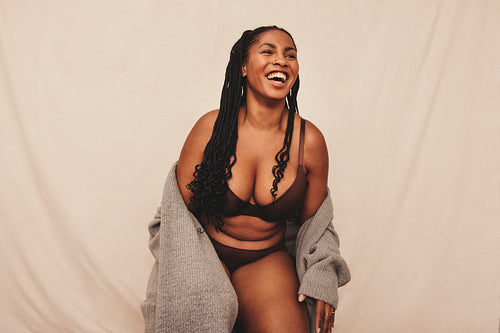 Young woman laughing cheerfully in a studio