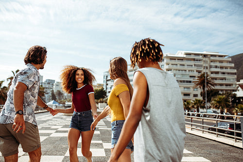 Beautiful woman walking with friends outdoors
