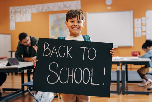 Excited child ready for first day of co-ed schooling and lifelong learning
