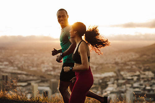 Couple running at sunrise