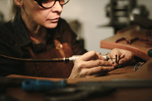 Goldsmith polishing a jewelry