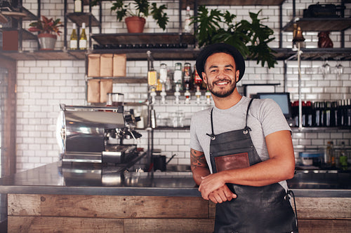 Proud coffee shop owner at the counter