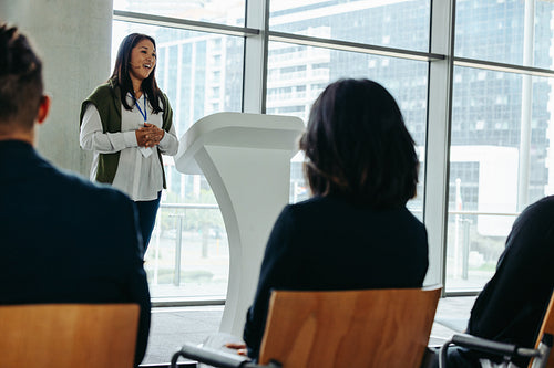 Businesswoman giving a presentation to an attentive audience at a business conference