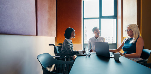 Diverse group of women in a business meeting discussing ideas together