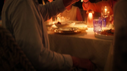 Family and friends enjoy a joyous dinner together on a tropical island vacation