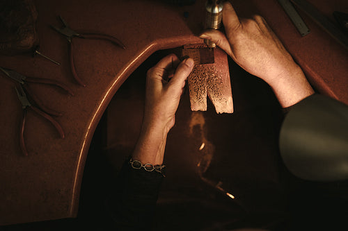 Jeweler making jewelry at her workbench
