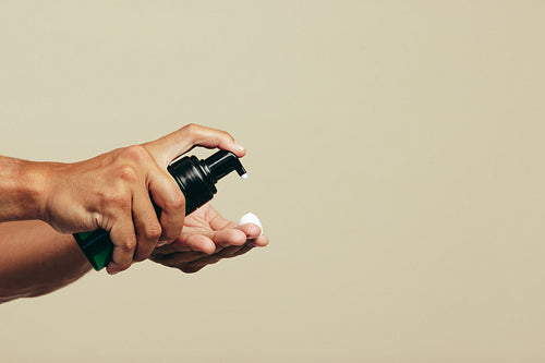 Man applying some face wash on his fingers