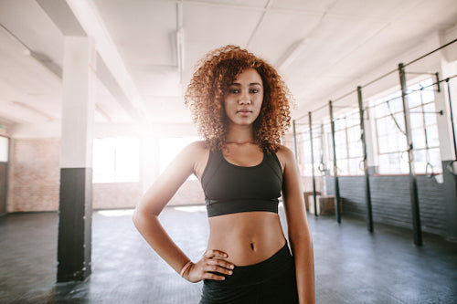 Determined african female standing in the gym