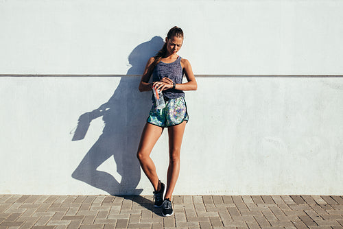 Female runner checking fitness progress