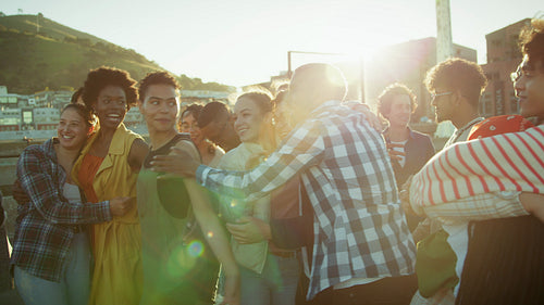 Happy friends laughing together outdoors