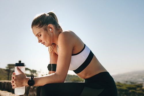 Woman in fitness wear relaxing after workout
