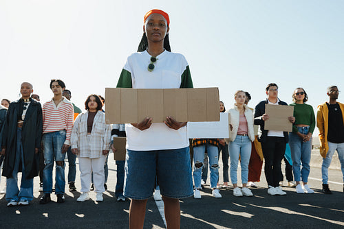 Diverse group of young people holding signs during a peaceful protest outdoors