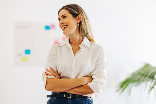 Cheerful businesswoman smiling happily in a creative office