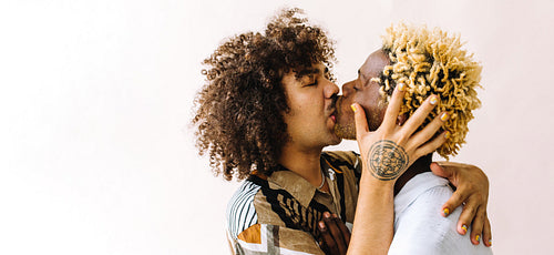 Passionate young gay couple sharing a kiss