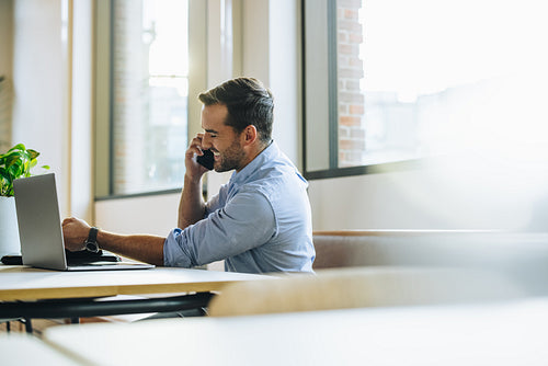 Man in office on cell phone