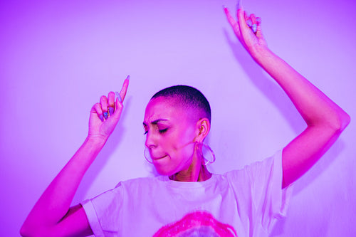 Hipster woman dancing to her favourite song at a party